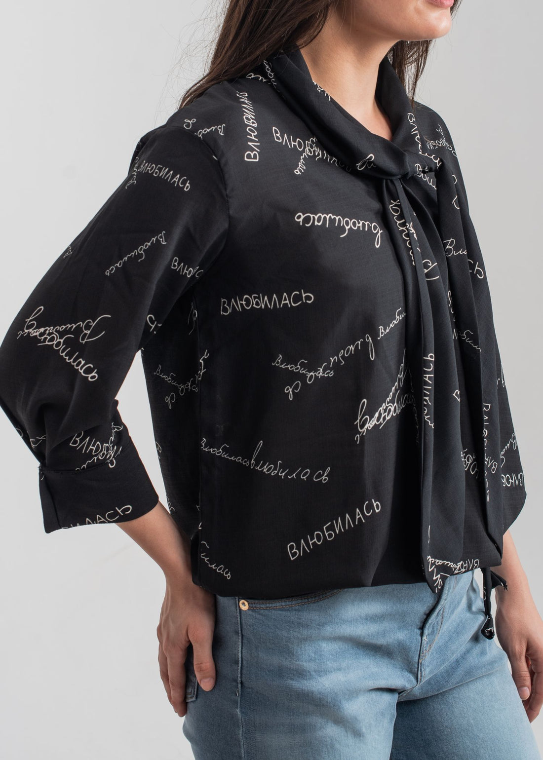 Women's printed bow top in black with a tie neck collar