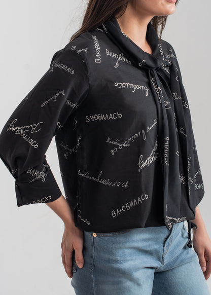Women's printed bow top in black with a tie neck collar