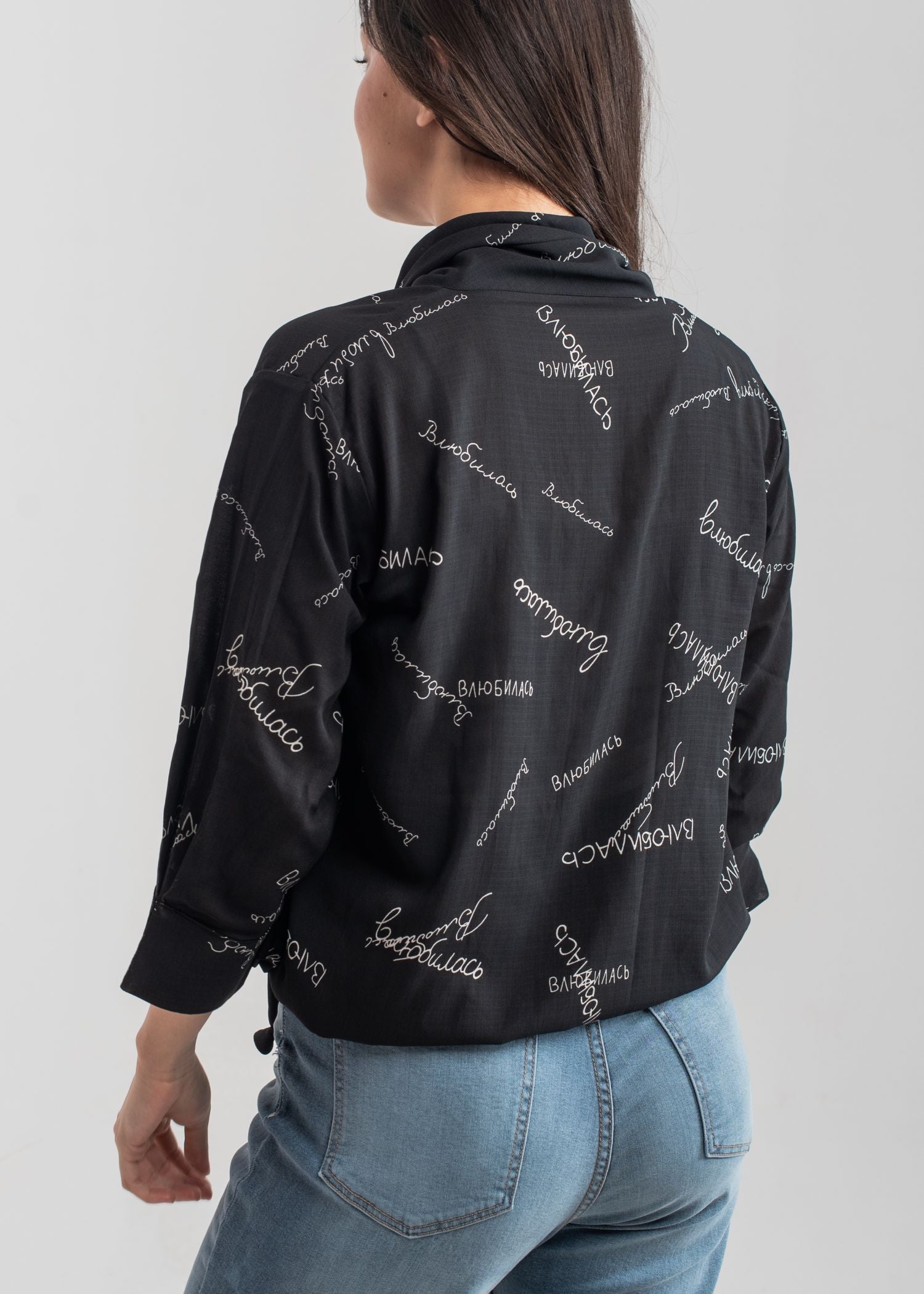 Women's printed bow top in black with a tie neck collar