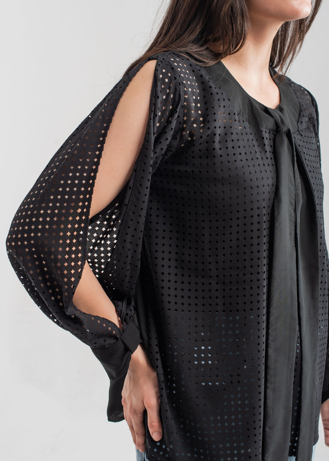Women's formal top in black with laser cut details