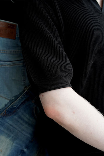 A Close-up of Men's Black Knitted Short Sleeve Polo