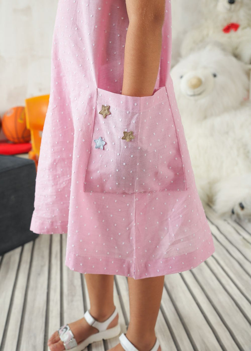 Girl's dress in pink with flower details and handy side pockets
