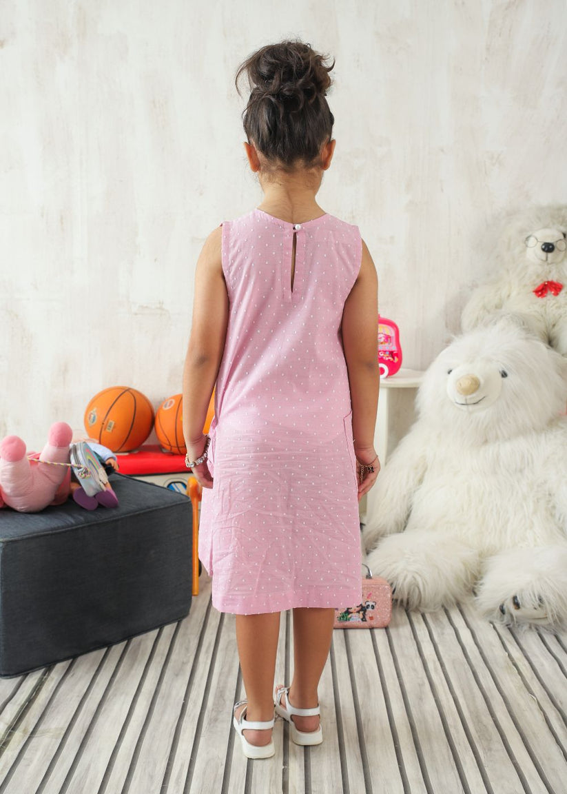 Girl's dress in pink with flower details and handy side pockets