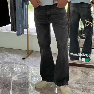 Person Wearing Faded Black Bootcut Jeans by 1947 Clothing