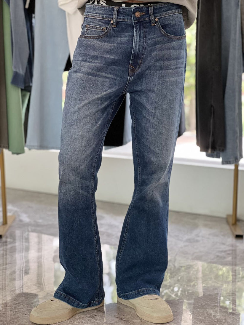 Person Wearing Mid Blue Bootcut Jeans by 1947 Clothing