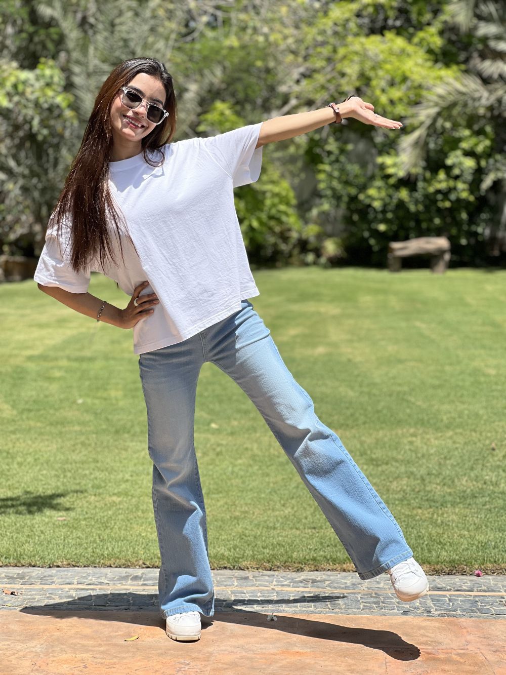 Girl Wearing Light Blue Flared Jeans made from Stretchable denim by 1947 Clothing