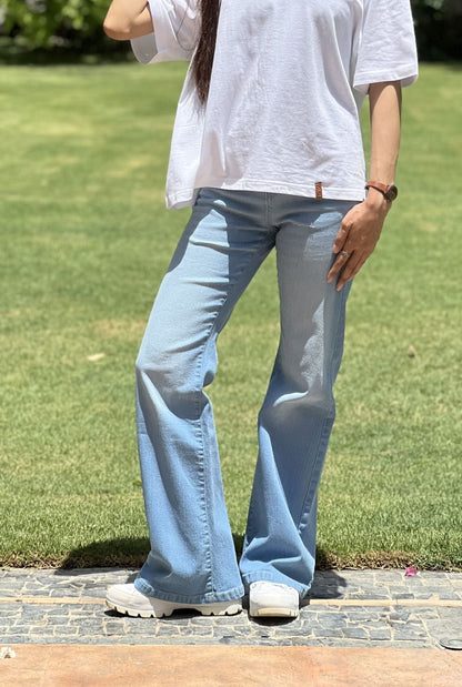 Girl Wearing Light Blue Flared Jeans made from Stretchable denim by 1947 Clothing