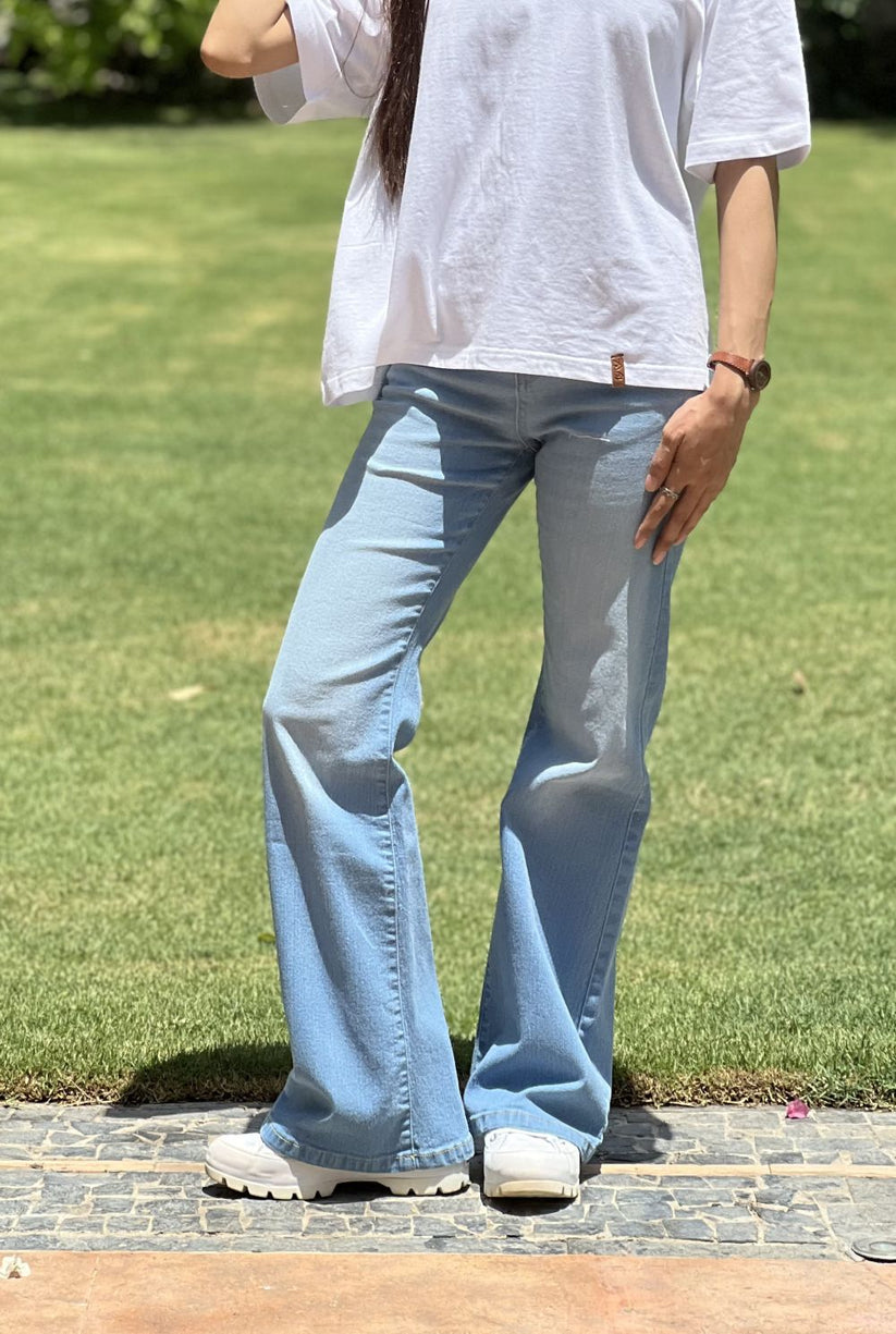 Girl Wearing Light Blue Flared Jeans made from Stretchable denim by 1947 Clothing