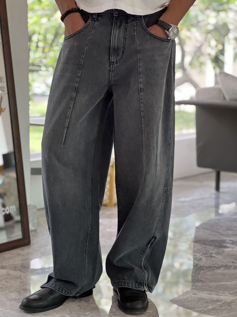 Person wearing gray baggy jeans indoors with a blurred background by 1947 clothing