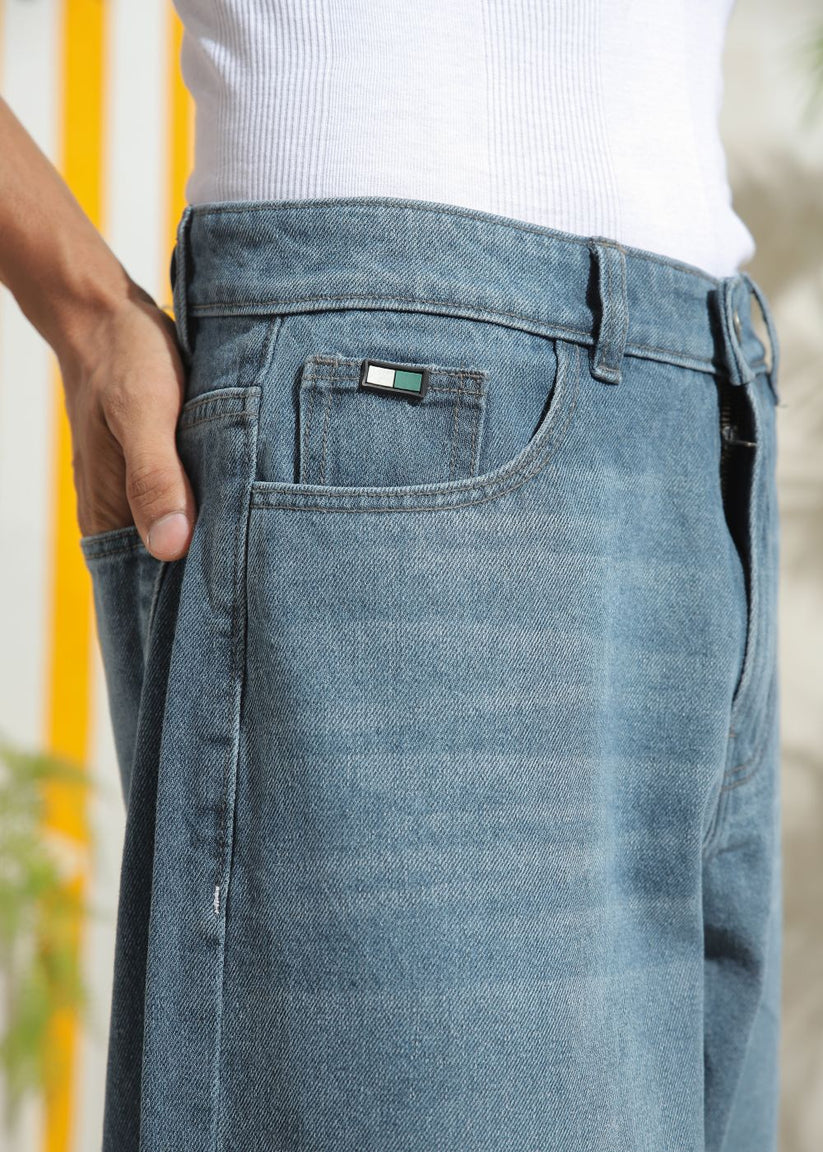 Men’s loose fit mid blue wide leg jeans with soft denim texture