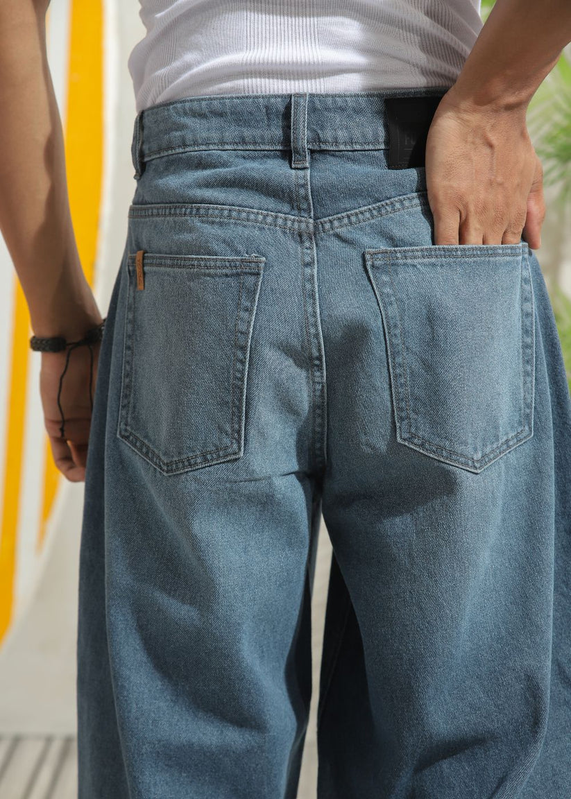 Men’s loose fit mid blue wide leg jeans with soft denim texture