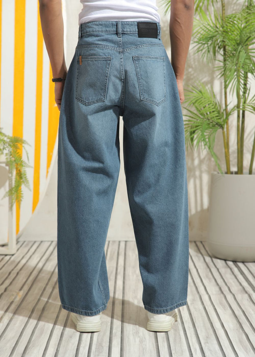 Men’s loose fit mid blue wide leg jeans with soft denim texture
