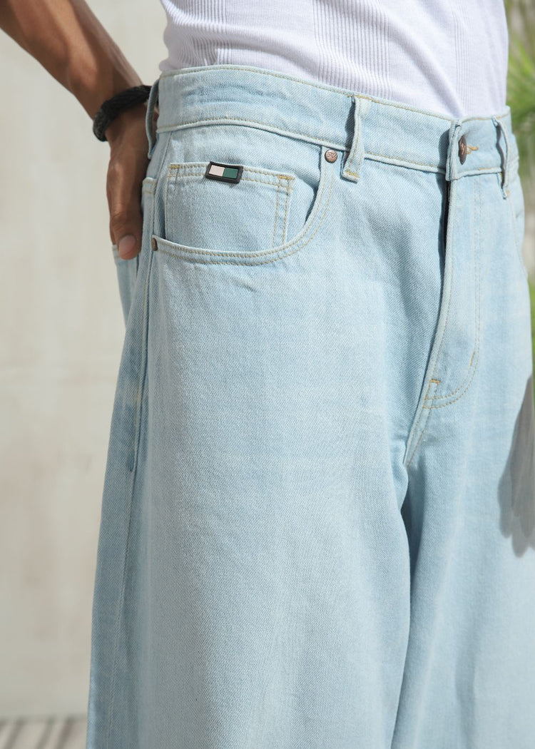 Men’s loose fit light wash blue wide leg jeans with clean finish