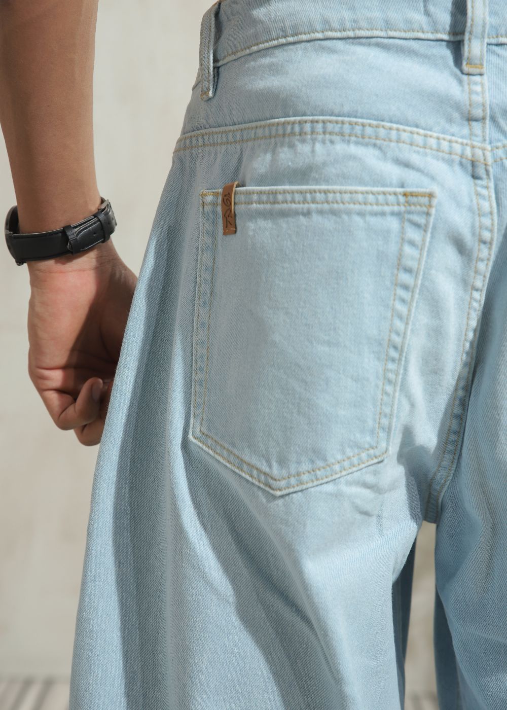 Men’s loose fit light wash blue wide leg jeans with clean finish