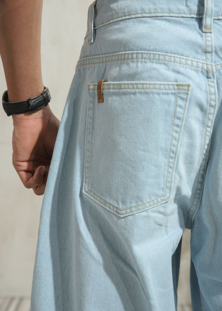 Men’s loose fit light wash blue wide leg jeans with clean finish