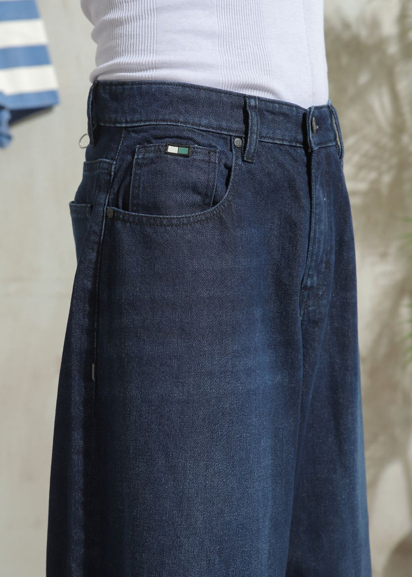 Wide-leg men’s denim jeans in dark blue with relaxed fit and clean minimal style