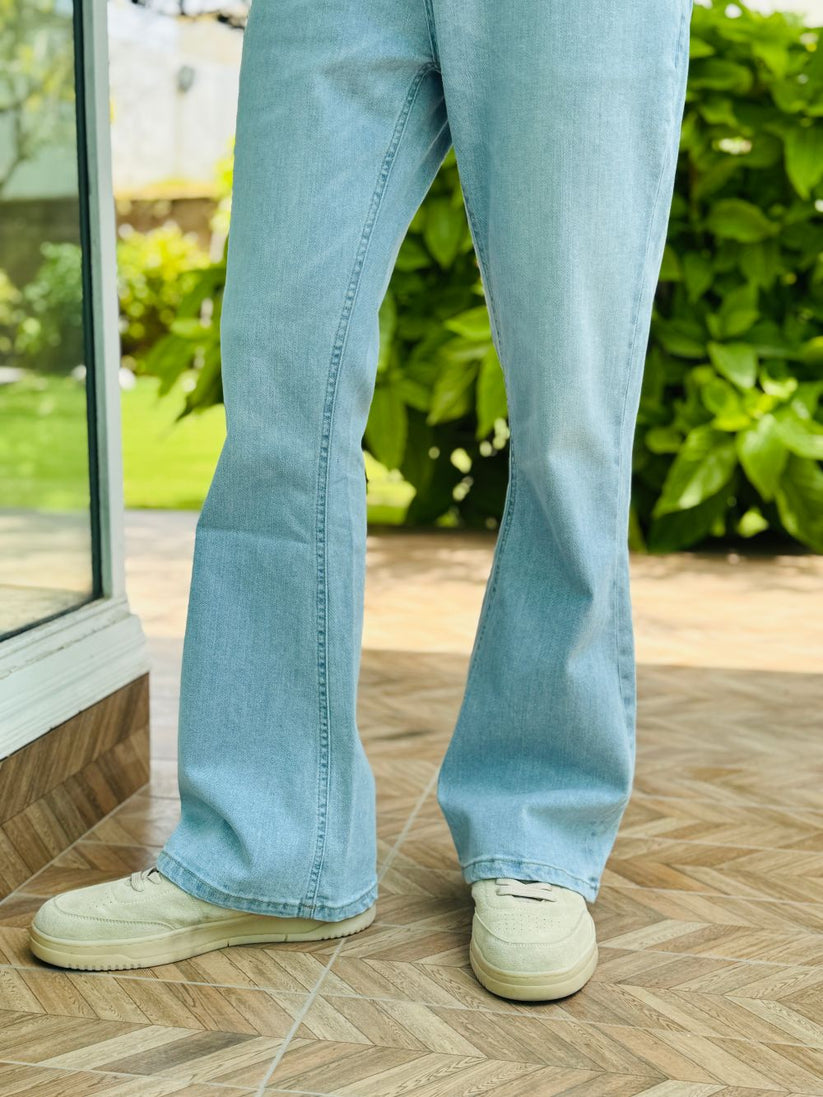 Person Wearing Ice Blue Bootcut Jeans by 1947 Clothing