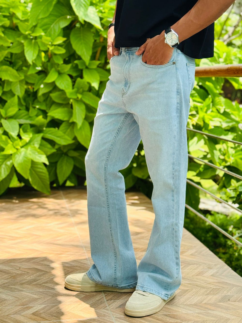 Person Wearing Ice Blue Bootcut Jeans by 1947 Clothing