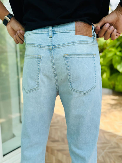 Person Wearing Ice Blue Bootcut Jeans by 1947 Clothing