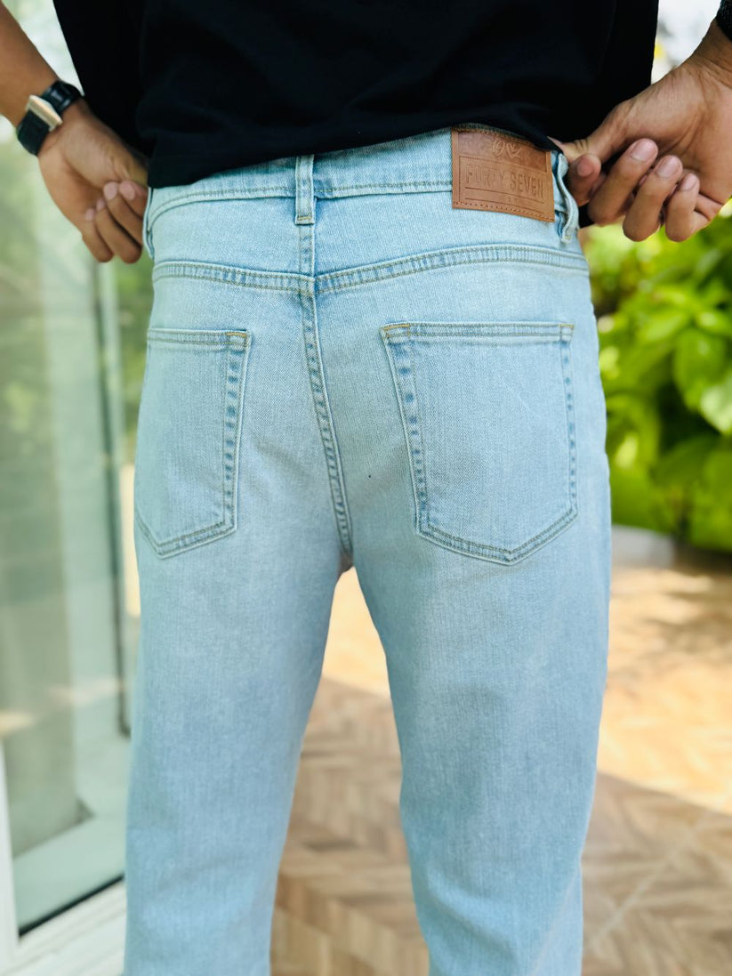 Person Wearing Ice Blue Bootcut Jeans by 1947 Clothing