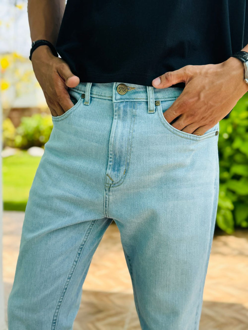 Person Wearing Ice Blue Bootcut Jeans by 1947 Clothing