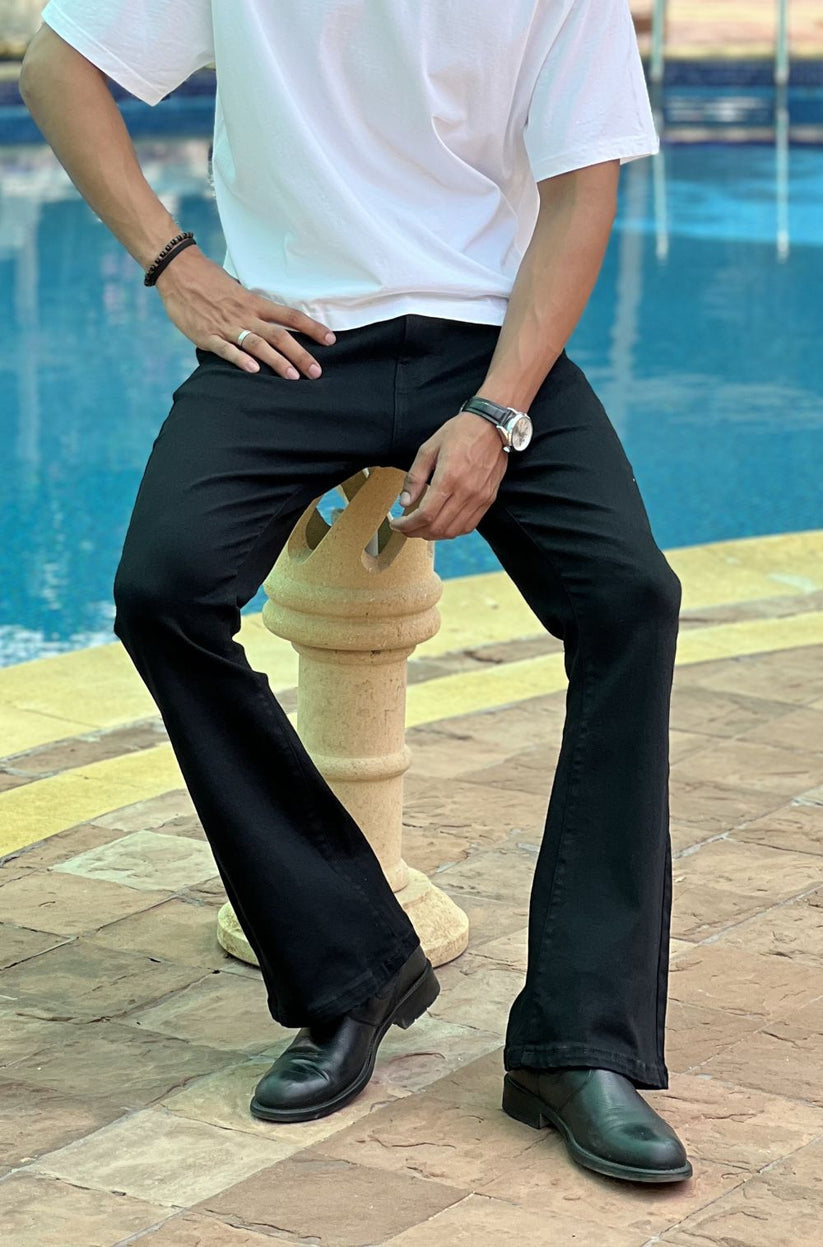 Person Wearing Jet Black Bootcut Jeans by 1947 Clothing