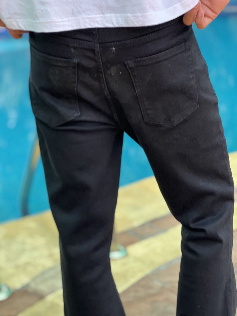 Person Wearing Jet Black Bootcut Jeans by 1947 Clothing