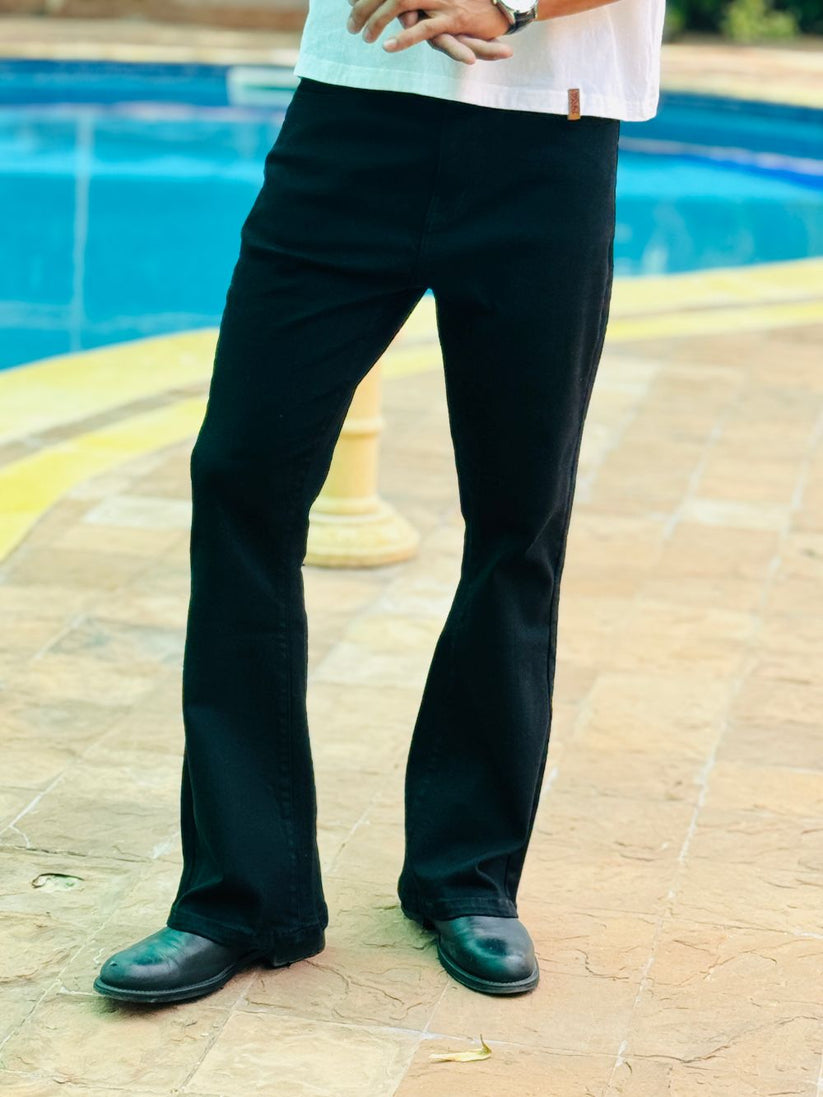 Person Wearing Jet Black Bootcut Jeans by 1947 Clothing