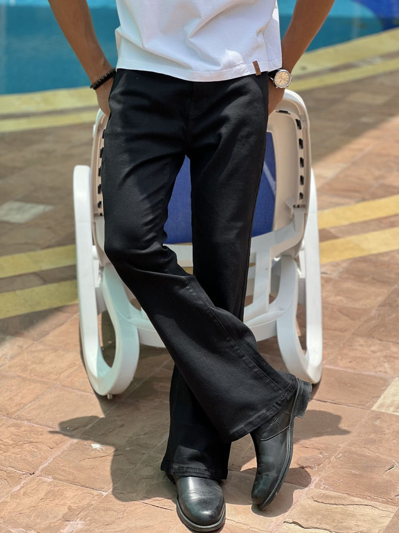 Person Wearing Jet Black Bootcut Jeans by 1947 Clothing