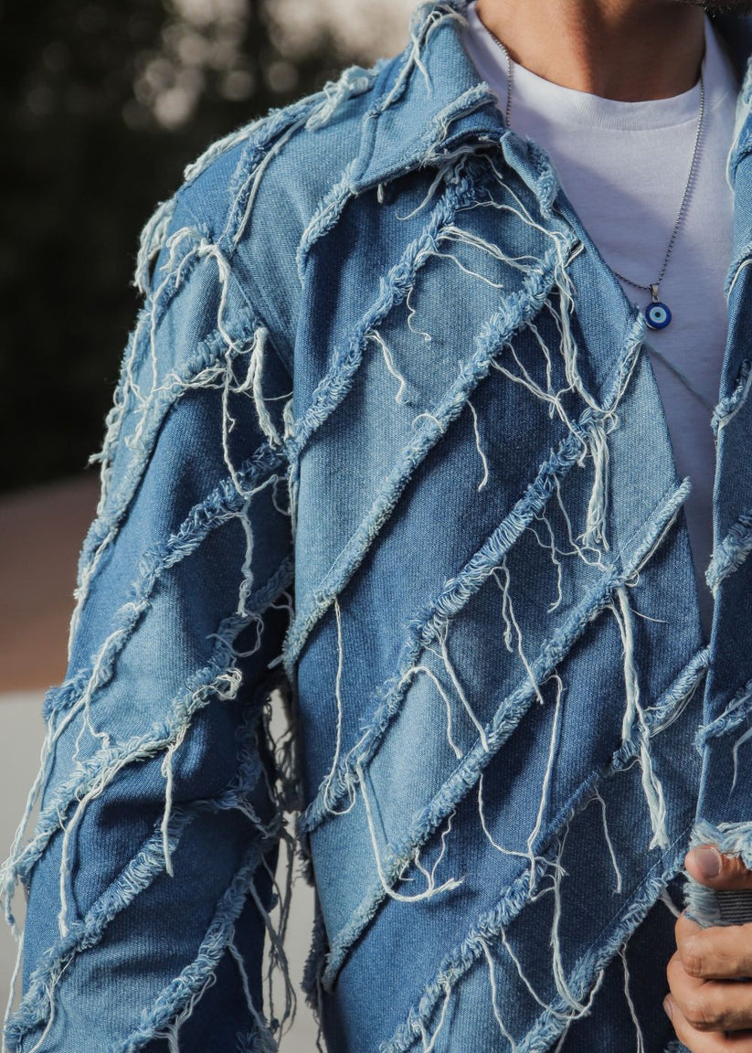 Men's light blue distressed denim jacket with frayed detailing