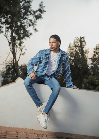 Men's light blue distressed denim jacket with frayed detailing