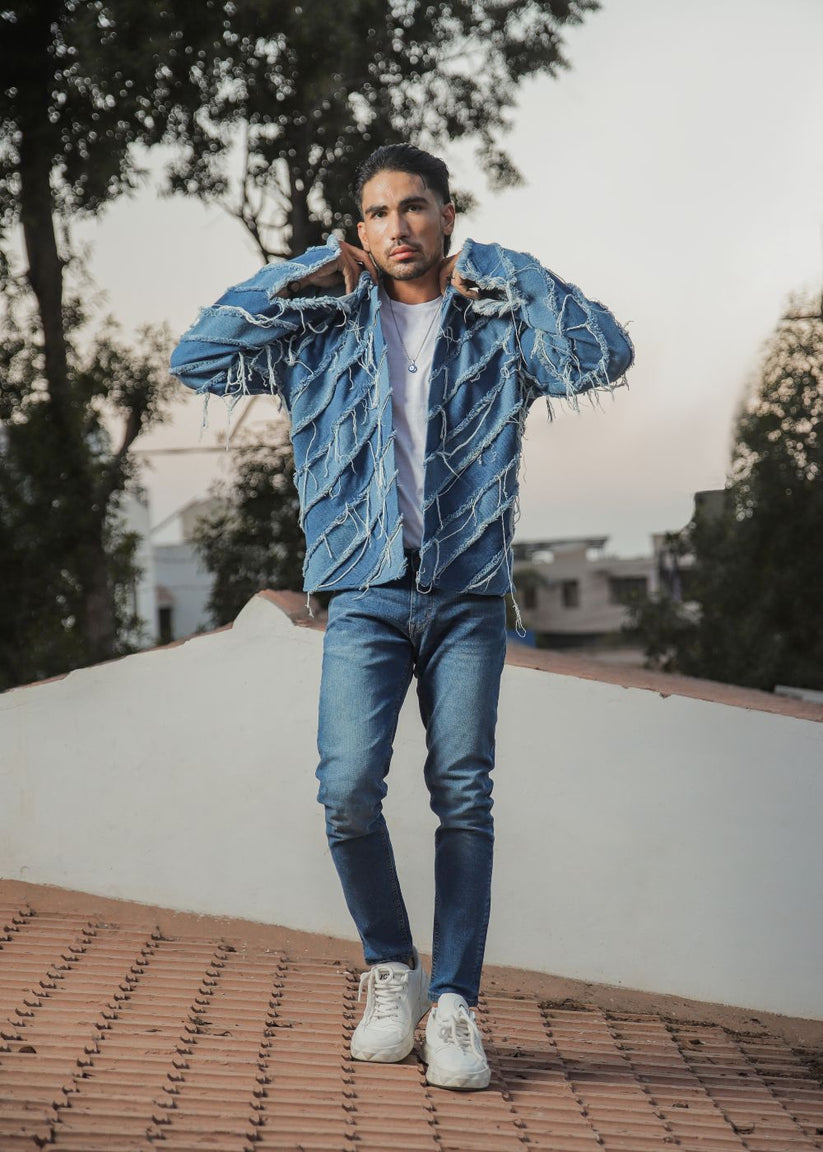 Men's light blue distressed denim jacket with frayed detailing