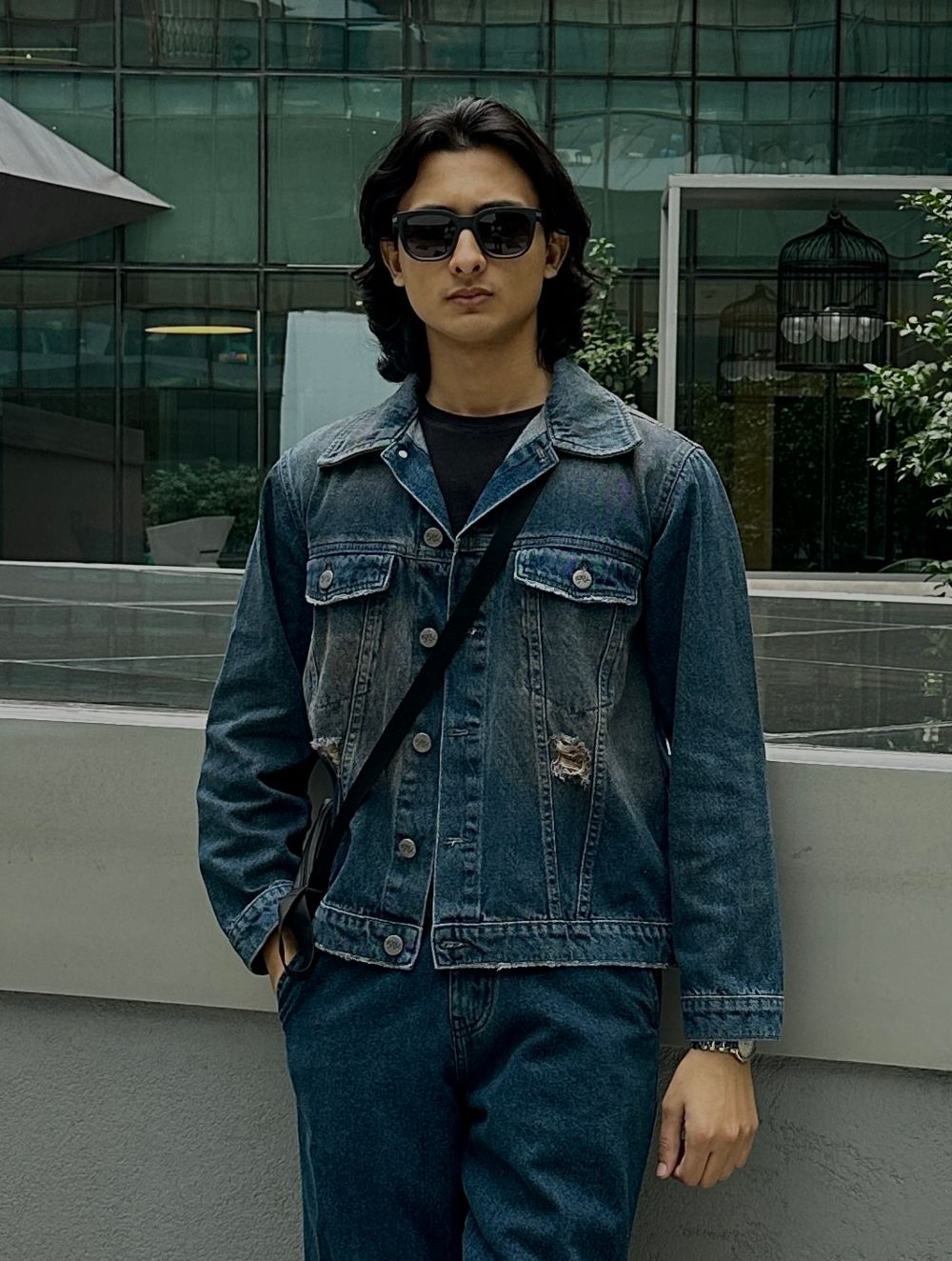 Men's rustic blue distressed denim jacket with ripped detailing