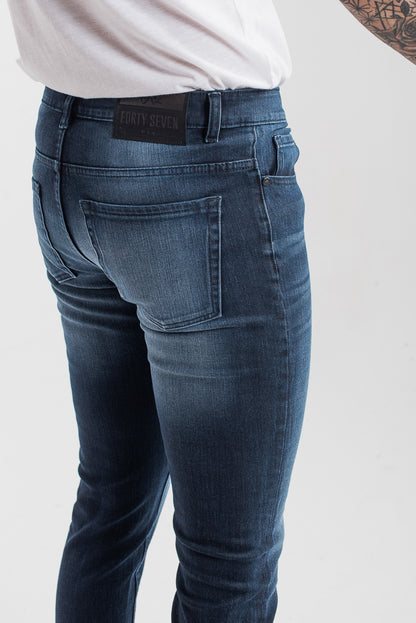 Men's slim fit dark blue jeans with whiskered wash detailing