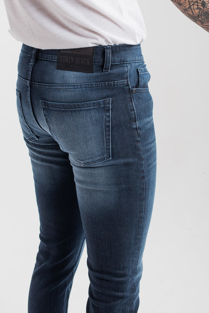 Men's slim fit dark blue jeans with whiskered wash detailing