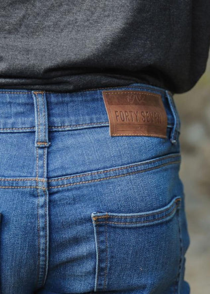 Men’s slim fit mid blue jeans with faded wash detailing