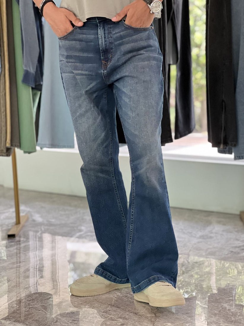 Person Wearing Mid Blue Bootcut Jeans by 1947 Clothing