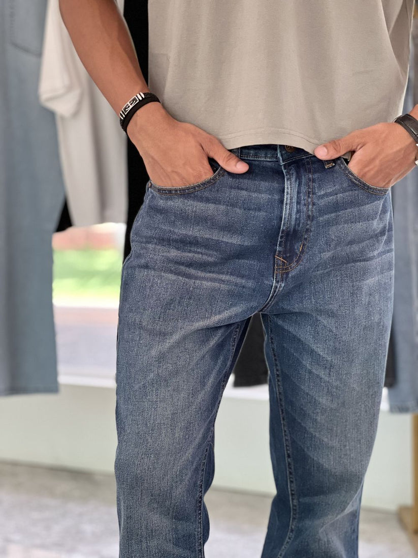Person Wearing Mid Blue Bootcut Jeans by 1947 Clothing