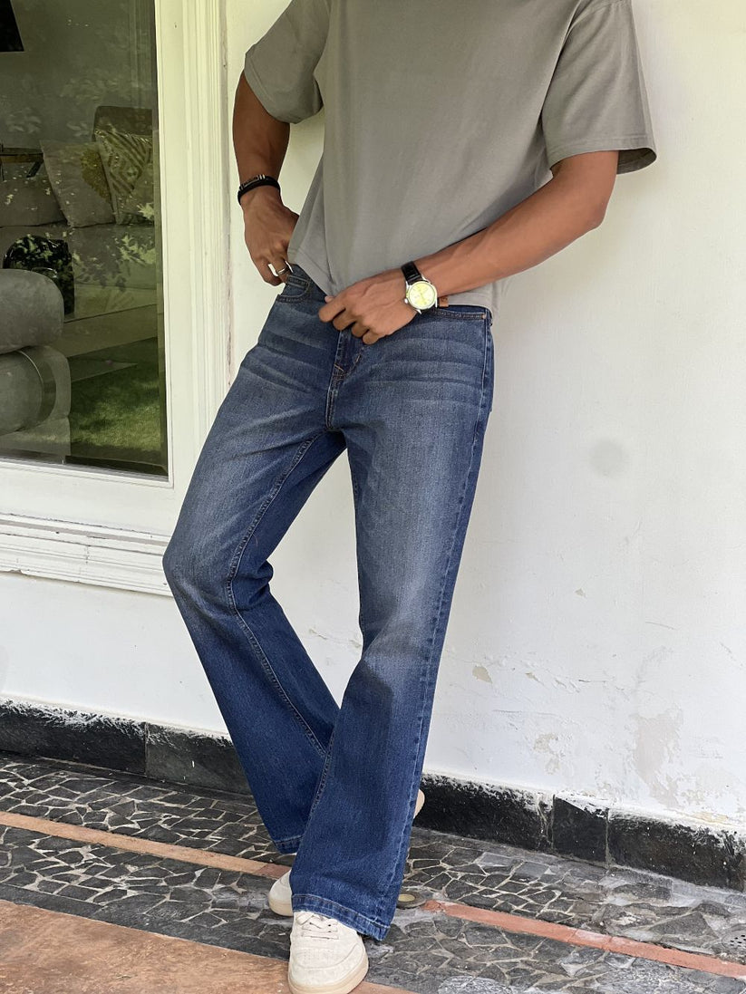 Person Wearing Mid Blue Bootcut Jeans by 1947 Clothing
