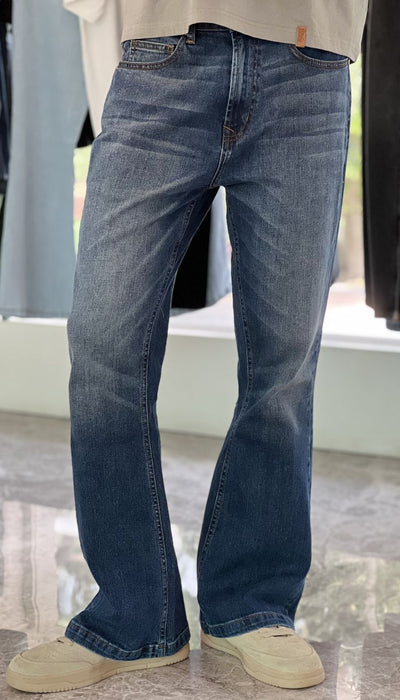 Person Wearing Mid Blue Bootcut Jeans by 1947 Clothing