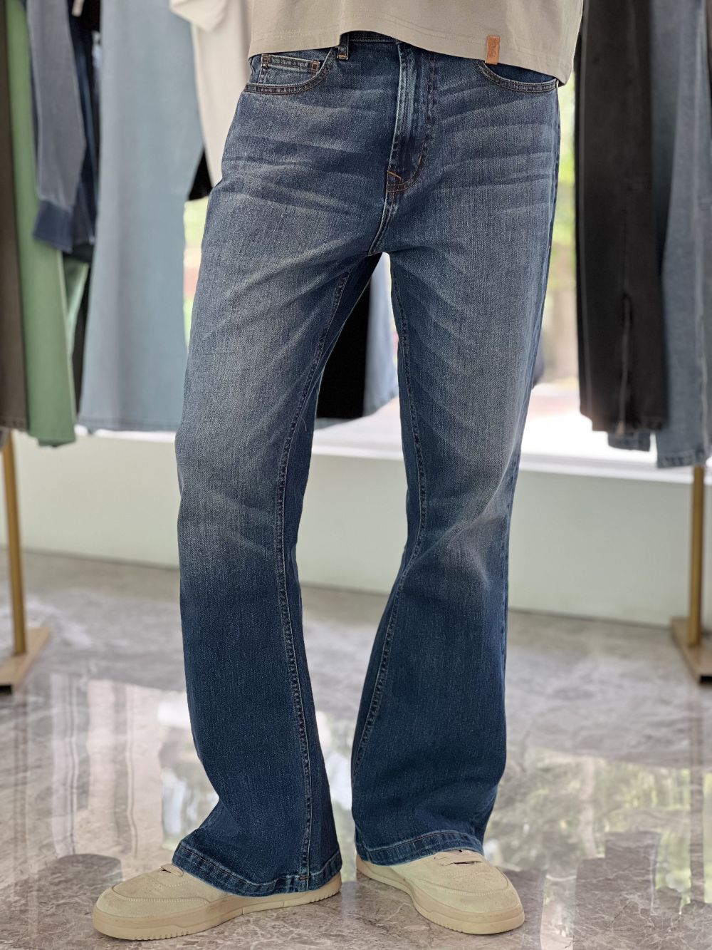 Person Wearing Mid Blue Bootcut Jeans by 1947 Clothing