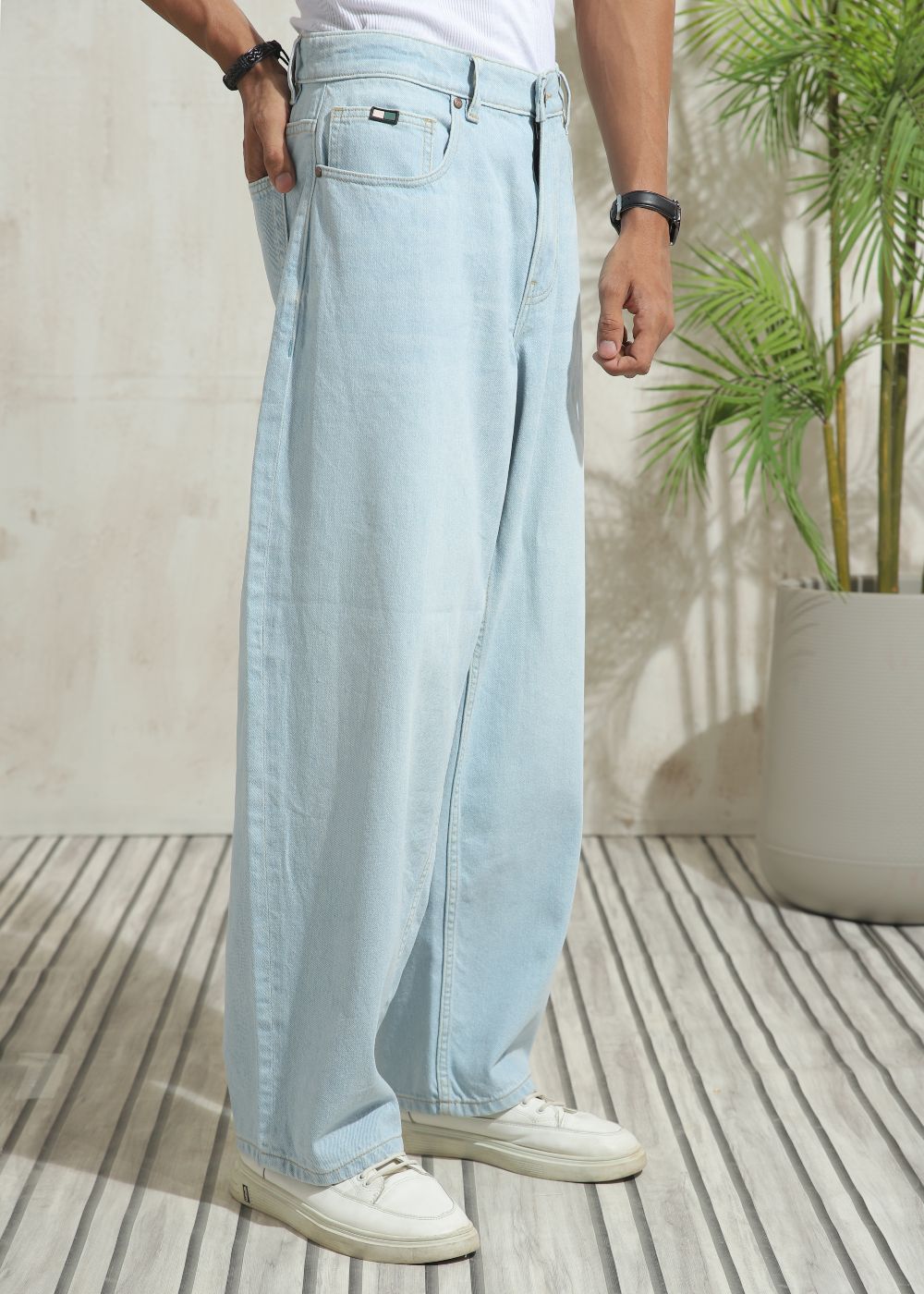 Men’s loose fit light wash blue wide leg jeans with clean finish