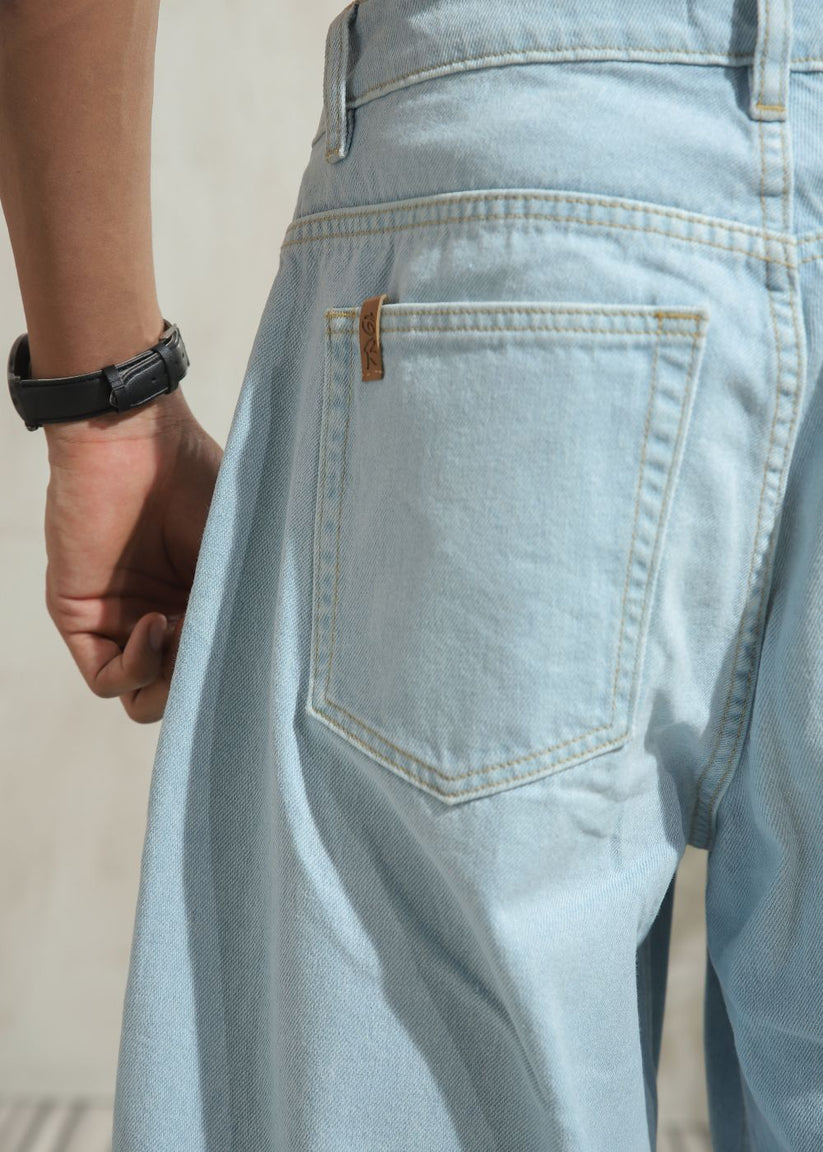 Men’s loose fit light wash blue wide leg jeans with clean finish