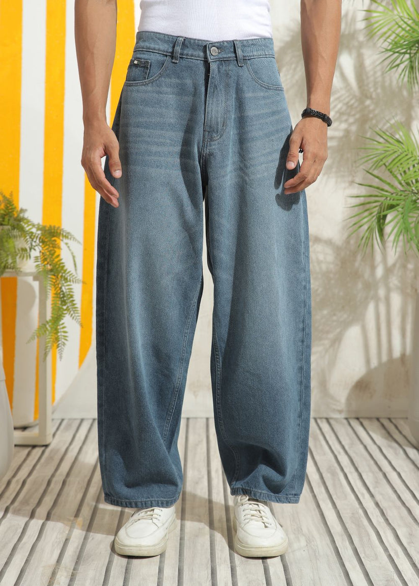 Men’s loose fit mid blue wide leg jeans with soft denim texture