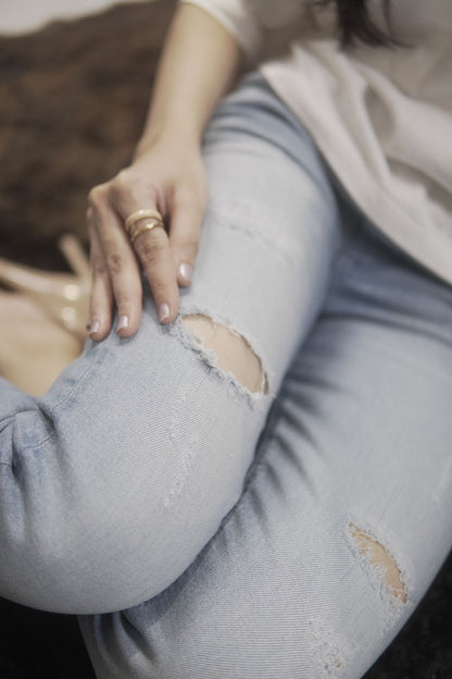 Women's Skinny Ripped Jeans in Light Blue Wash Featuring a Zipper Fly and Handmade Ripped and Repaired Abrasions