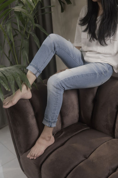 Women's Skinny Ripped Jeans in Light Blue Wash Featuring a Zipper Fly and Handmade Ripped and Repaired Abrasions