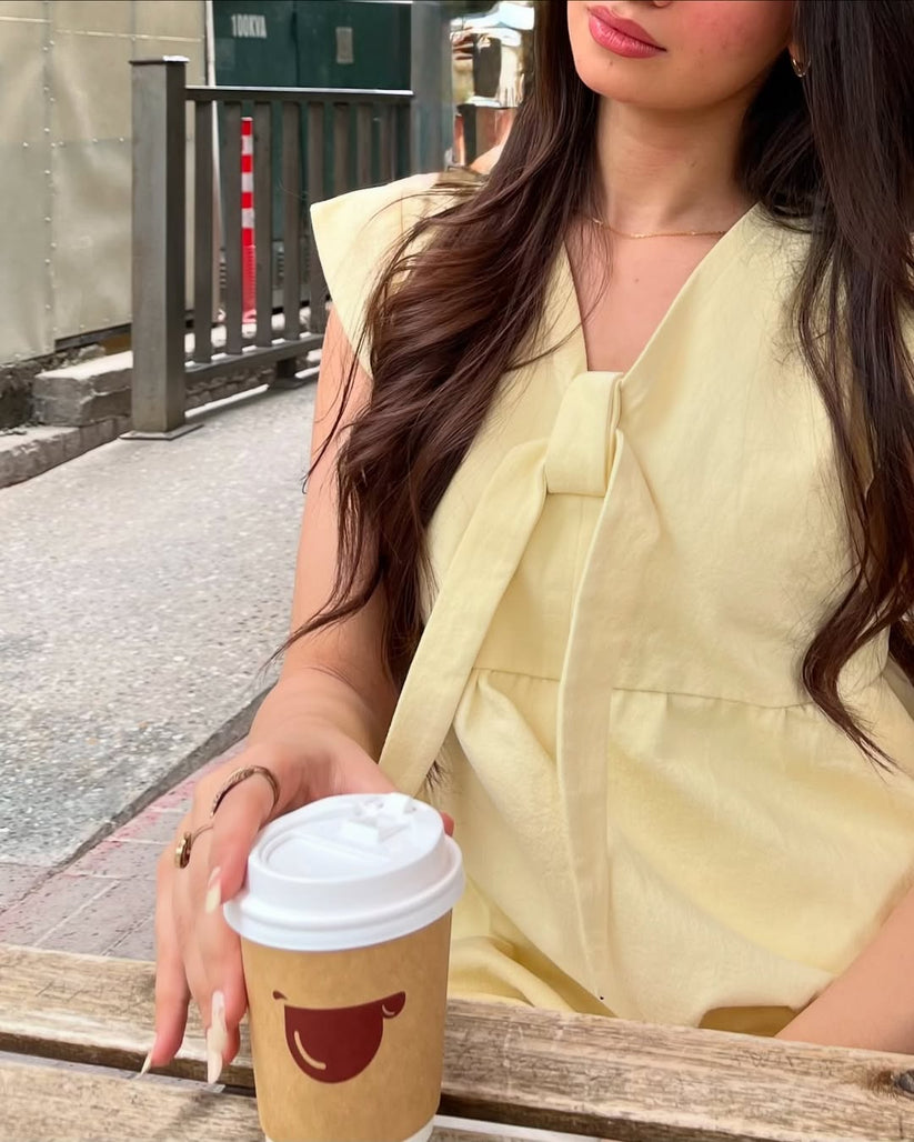 Ladies Peplum Top in Pastel Yellow Featuring a Charming Bow Tie in the Front