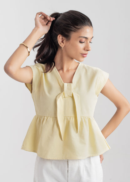 Ladies Peplum Top in Pastel Yellow Featuring a Charming Bow Tie in the Front
