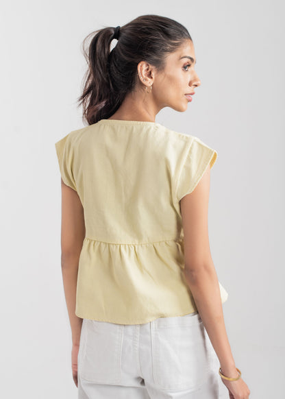 Ladies Peplum Top in Pastel Yellow Featuring a Charming Bow Tie in the Front