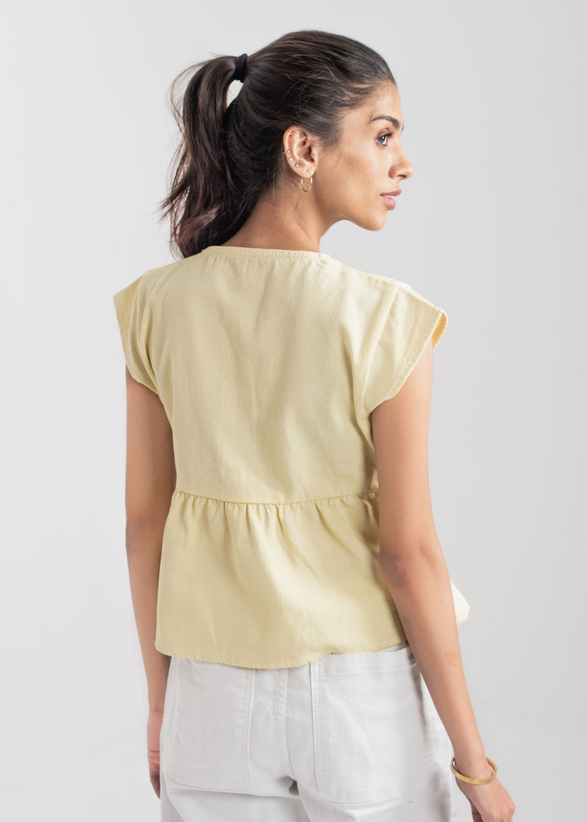 Ladies Peplum Top in Pastel Yellow Featuring a Charming Bow Tie in the Front